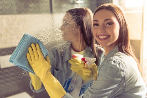 Local cleaner working on glass windows at a Knightsbridge apartment building